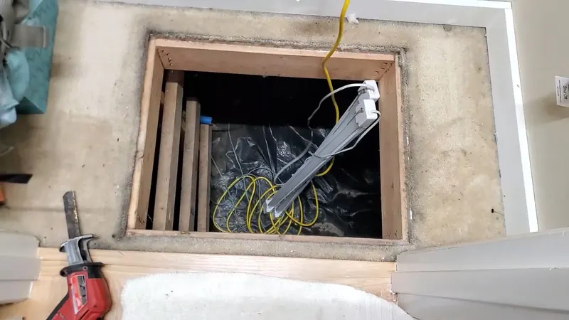 Close view of crawlspace drain pipe repair below a home for plumbing service in Cedar Cliff