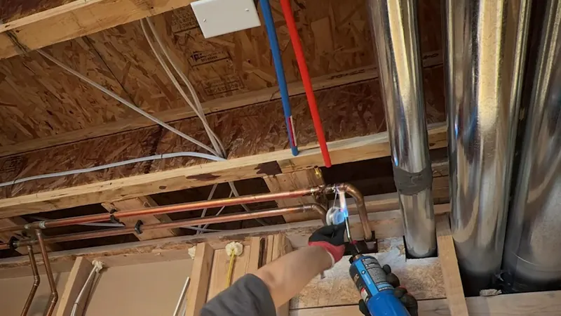 Close view of drain cleaning tool working at a clogged line for plumbing service in Silver Spring Township