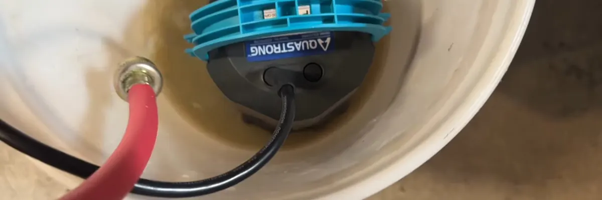Wide view of garbage disposal wiring and drain connection under a sink for Garbage Disposal Repair Replacement service in Mechanicsburg