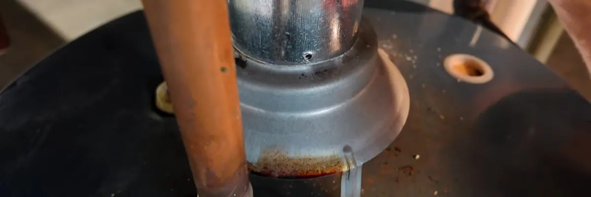 Wide view of gas line valve and appliance connection being serviced for Water Heater Repair Replacement service in Mechanicsburg