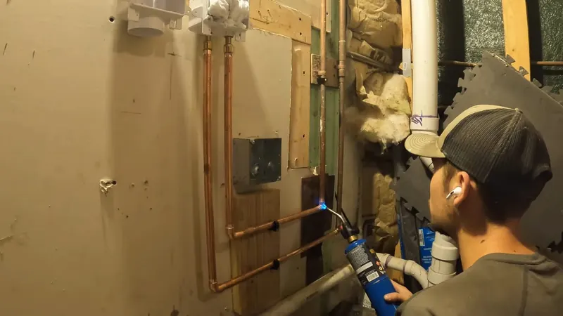 Close view of kitchen sink drain and supply plumbing being installed for plumbing service in Summerdale