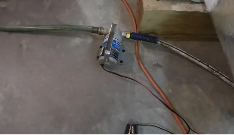 Sump pump basin and discharge piping in a basement for Preparing Your Sump Pump for Spring: West Shore PA
