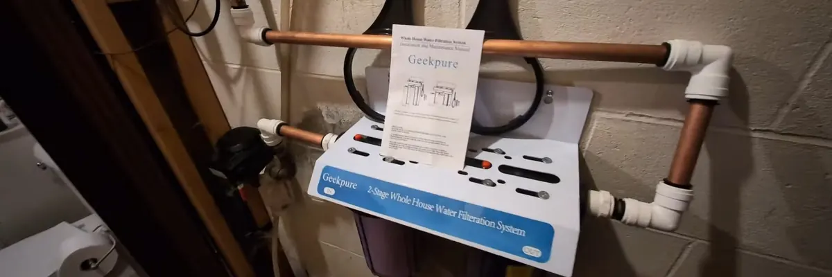 Wide view of whole-house water filtration equipment connected to plumbing for Water Filtration service in Mechanicsburg